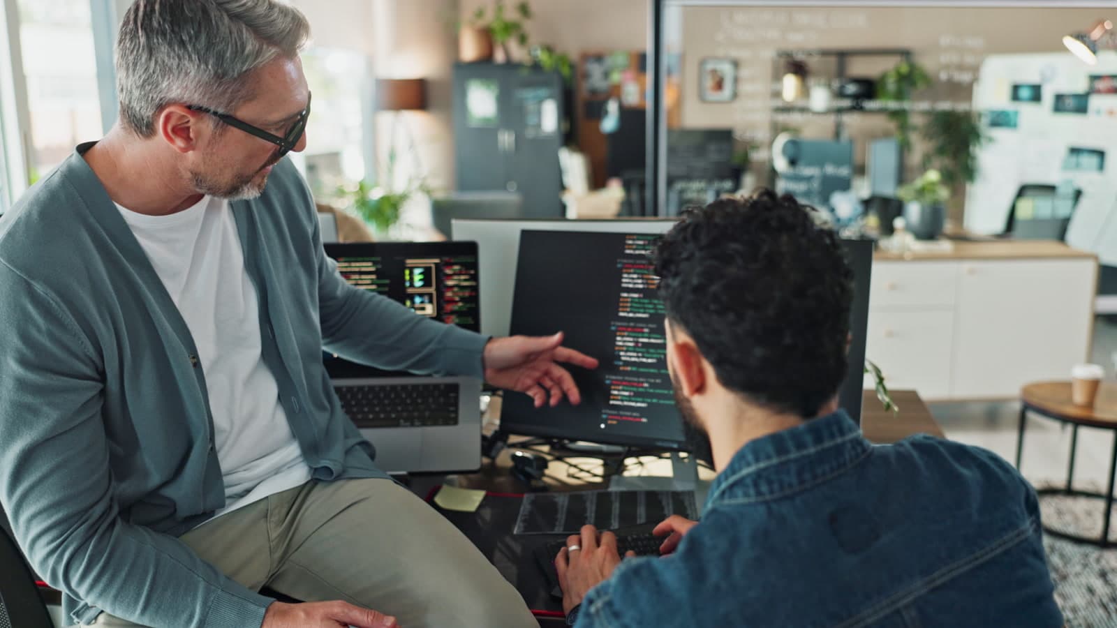 Two engineers reviewing code together during a data and intelligence consulting project, Whitehot Melbourne.